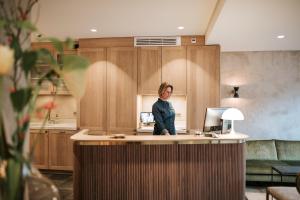 a woman standing at a counter in a kitchen at The Times Hotel in Amsterdam