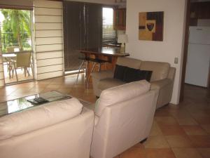 a living room with a couch and a table at Fairthorpe Apartments in Brisbane