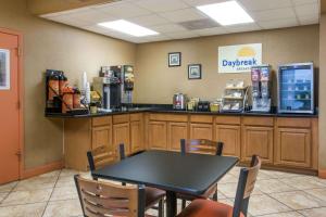 a dining room with a table and chairs in a restaurant at Days Inn by Wyndham Ormond Beach in Ormond Beach