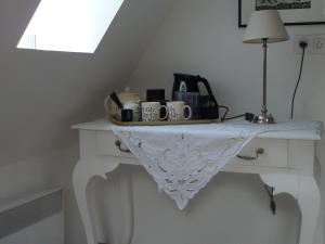 a white table with appliances on top of it at B&B La Baronniére in Cordebugle