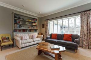 a living room with a couch and a coffee table at Gate House - Vivre Retreats in Wimborne Minster