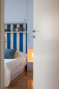 um quarto com uma cama com riscas azuis e brancas em Relax Makarska em Makarska