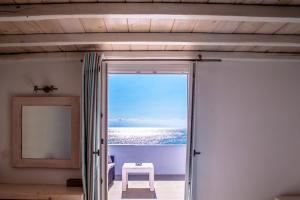 a door to a room with a view of the ocean at Paradise Beach Resort in Paradise Beach
