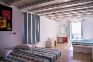 A bed or beds in a room at Paradise Beach Resort