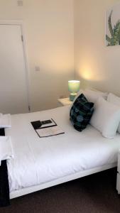 a white bed with two pillows on top of it at The Star Inn in Nottingham