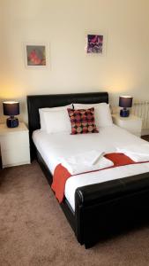 a bedroom with a bed with two lamps on two tables at The Star Inn in Nottingham