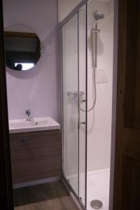 a bathroom with a shower and a sink at The Buttery at Trussel Barn in Liskeard