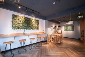 a room with a bar with stools in it at Luke 27 Homestay in Tainan +46 photos