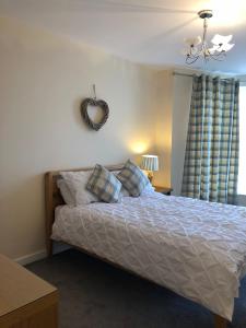 a bedroom with a bed with a heart mirror on the wall at Morecambe sea view apartment 203 in Morecambe