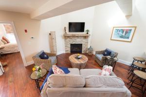 a living room with a couch and a fireplace at The Newport Lofts - 543 Thames Street in Newport