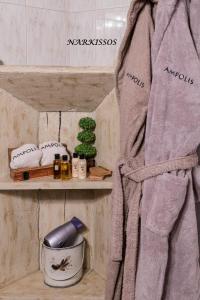 a towel on a shelf in a bathroom at Ampolis Guest House in Arachova