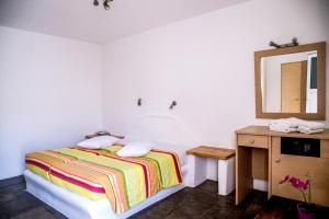 a bedroom with a bed and a mirror at Paradise Beach Resort in Paradise Beach