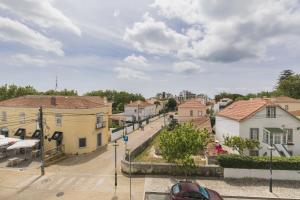 a view of a town with houses and a street at modern flat in Estoril