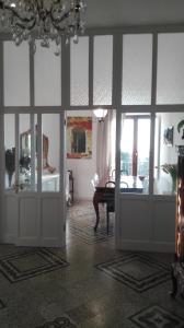 a living room with a table and glass doors at AL 32 B&B in Massa Marittima