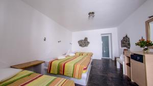 a bedroom with two beds in a room at Paradise Beach Resort in Paradise Beach