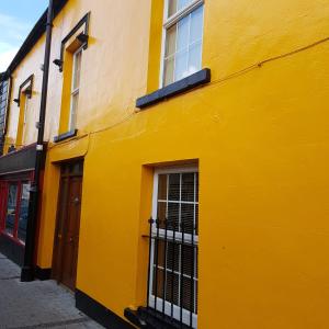 un edificio amarillo con ventanas en una calle en Bridge House, en Carrick on Shannon