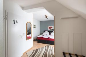 A bed or beds in a room at Wein & Gästehaus Ballmann