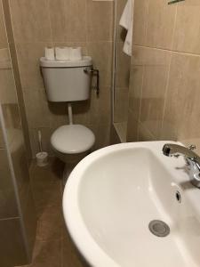 a bathroom with a white sink and a toilet at Seven Dials Hotel in London +17 photos