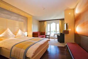 A bed or beds in a room at Revier Hotel Säntispark