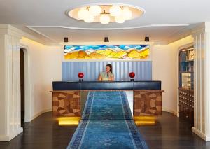 a woman standing in front of a bar in a room at The Standard - East Village in New York