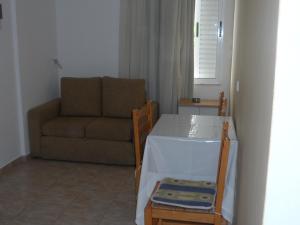 a living room with a couch and a table at Villa Giorgos in Kefalos