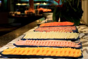 a row of different types of food on a counter at Tivoli Ecoresort Praia do Forte in Praia do Forte
