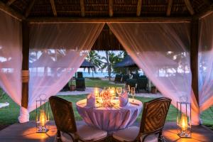 a table with candles and chairs in a tent at Tivoli Ecoresort Praia do Forte in Praia do Forte