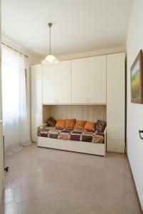 a bedroom with a bed and white cabinets at The Sea View Mountain Apartment in Fasano