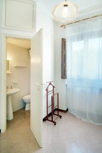 a bathroom with a toilet and a sink at The Sea View Mountain Apartment in Fasano