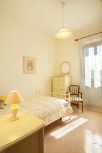 a bedroom with a bed and a desk and a chair at The Sea View Mountain Apartment in Fasano
