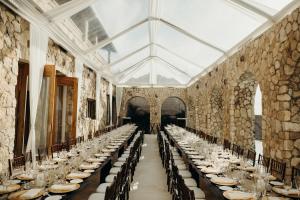 a long dining room with long tables and chairs at Pattoo Castle in Negril