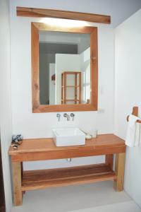 a bathroom with a sink and a mirror at Pattoo Castle in Negril