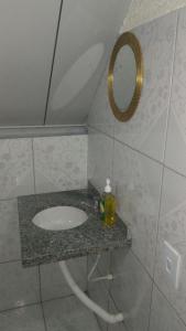 La salle de bains est pourvue d'un lavabo et d'un miroir. dans l'établissement Pousada Encanto do Jalapão, à São Félix do Tocantins