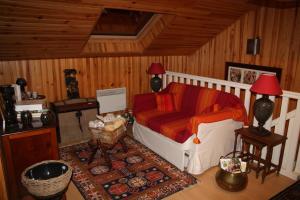 a living room with a couch and a table at leschambresdanne in Chameyrat