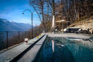 a swimming pool with a view of the mountains at Il Nido del Casalot in Frassino