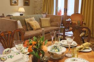 a living room with a table with dishes on it at Oundle Bespoke Apartments in Oundle +44 photos