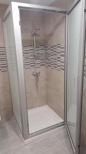 a shower with a glass door in a bathroom at Manoli Apartments in Ayia Napa