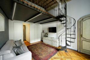 a living room with a couch and a spiral staircase at Turin Art Experience in Turin