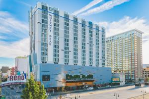 a large building in a city with a street at Whitney Peak Hotel Reno, Tapestry Collection by Hilton in Reno