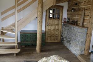 a room with a staircase and a stone wall at Buflaczanka in Nowy Targ