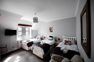 a bedroom with two beds and a tv in it at No. 1 Caberfeidh in Fort William