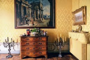 a dresser in a room with a painting on the wall at Turin Art Experience in Turin