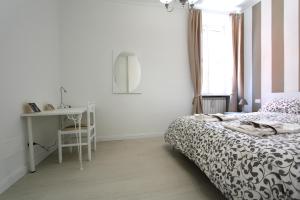 a bedroom with a bed and a desk and a window at Adriatico Turin Centre in Turin