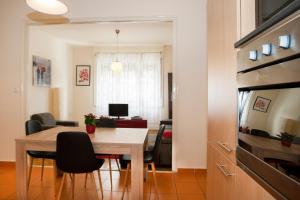 a kitchen and dining room with a table and chairs at Georgina apartment in Budapest