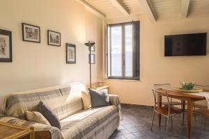 a living room with a couch and a table at Amartìa Apartments in Taormina