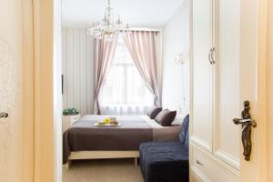 a small bedroom with a bed and a window at Avenue in Saint Petersburg
