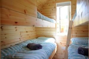 A bed or beds in a room at Coach Field Camp