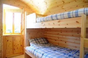 A bed or beds in a room at Coach Field Camp