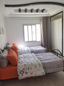 a bedroom with two twin beds and a window at Well located apartment in Casablanca- 12 MO internet- Netflix in Casablanca