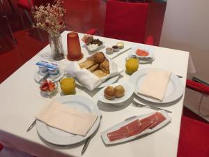 a white table topped with plates of food at Hotel Palacio Garvey in Jerez de la Frontera
